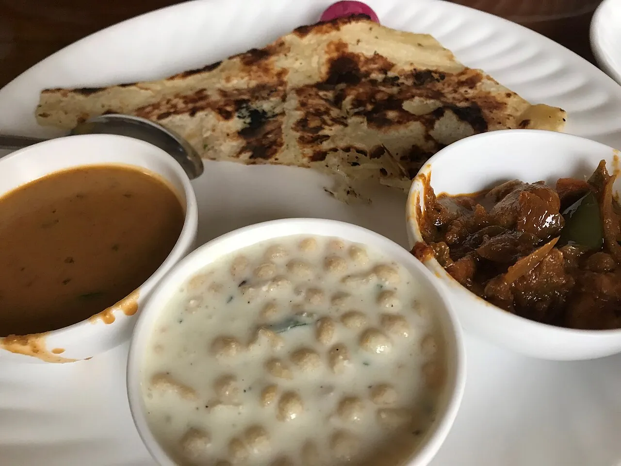 Lachha paratha with dal makhani, dahi bhalla and a curry