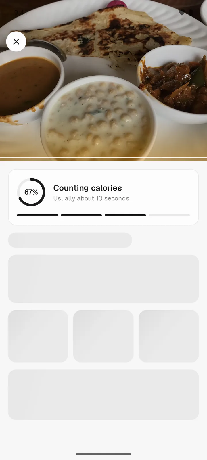 Instant Calorie reading a photo of paratha with dal and sabzi, 67 percent done